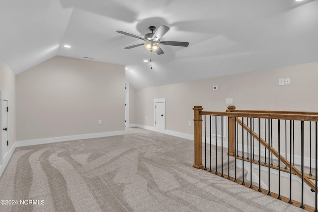 additional living space featuring baseboards, lofted ceiling, recessed lighting, ceiling fan, and light colored carpet