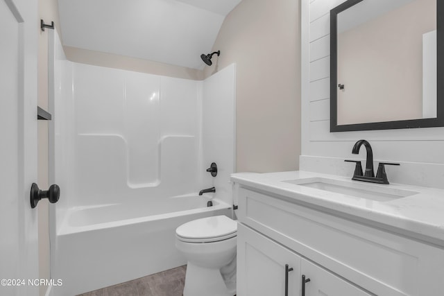 full bath with vanity, vaulted ceiling, toilet, and shower / washtub combination