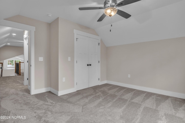 bonus room featuring baseboards, lofted ceiling, carpet floors, and a ceiling fan