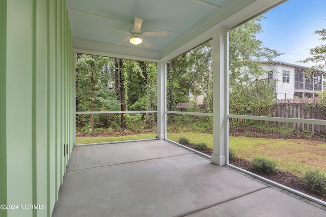 unfurnished sunroom featuring a ceiling fan