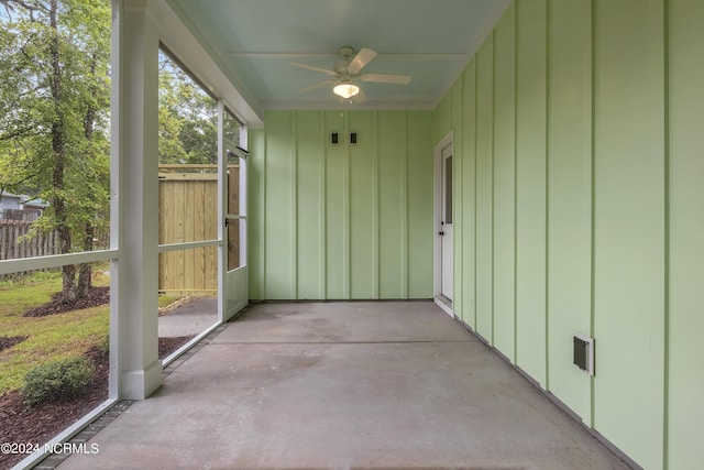 unfurnished sunroom with ceiling fan