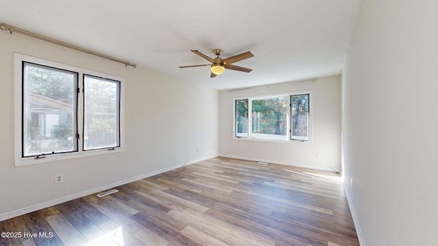 unfurnished room with ceiling fan and light hardwood / wood-style floors