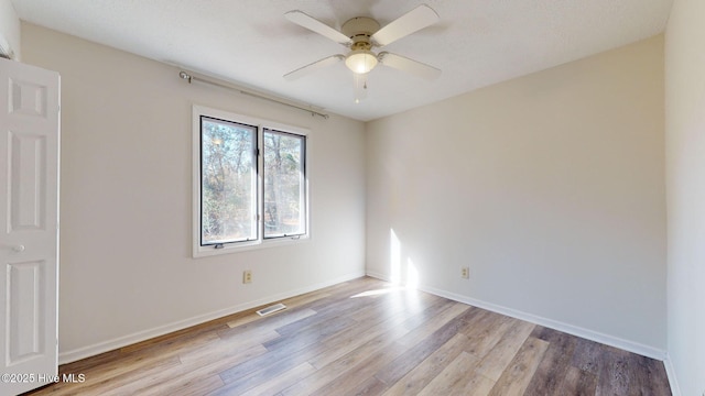 spare room with ceiling fan and light hardwood / wood-style floors