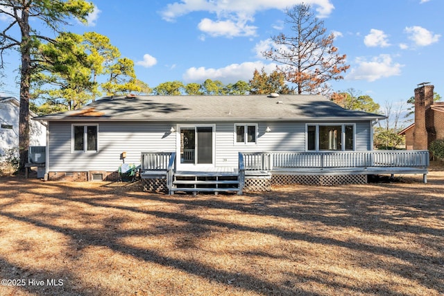 rear view of property featuring a wooden deck