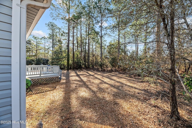 view of yard featuring a wooden deck