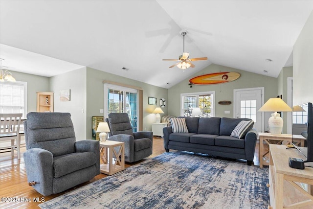 living room with hardwood / wood-style flooring and vaulted ceiling