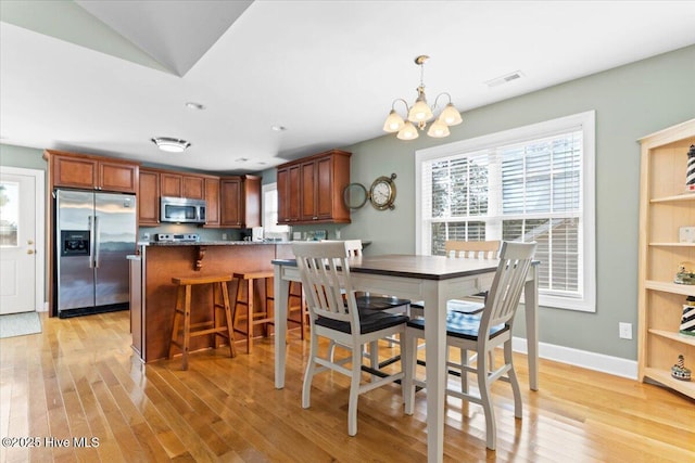 dining room featuring a chandelier and light hardwood / wood-style flooring