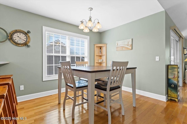 dining room with a notable chandelier and light hardwood / wood-style flooring