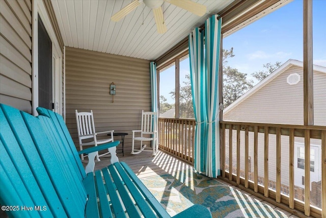 sunroom featuring ceiling fan