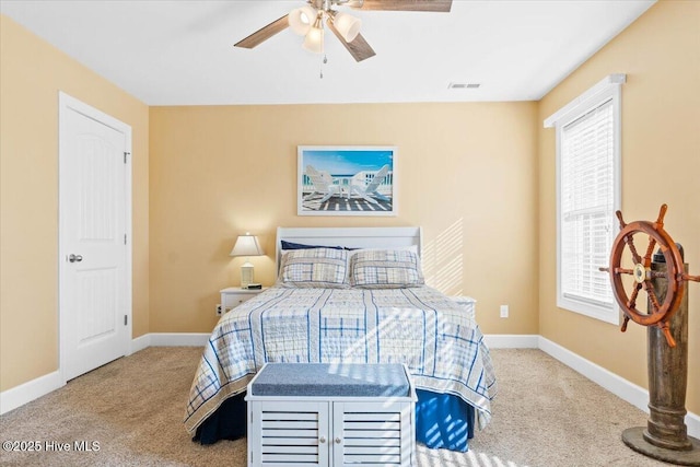 bedroom featuring ceiling fan and carpet