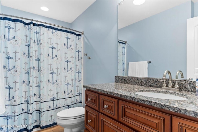 bathroom with vanity, a shower with curtain, and toilet