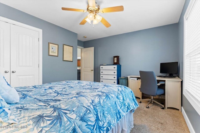 carpeted bedroom with ceiling fan and a closet