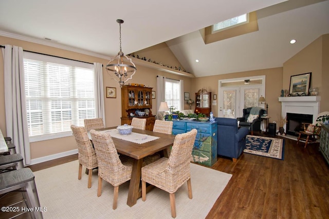 dining area featuring lofted ceiling, a chandelier, and dark hardwood / wood-style flooring