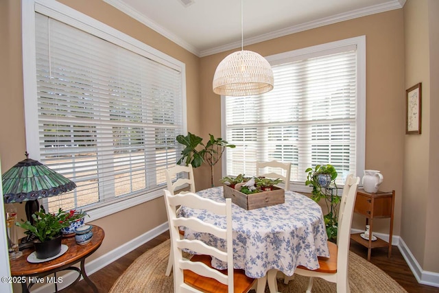 dining room featuring dark wood-type flooring and ornamental molding