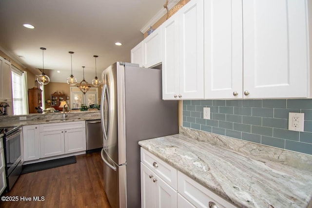 kitchen with pendant lighting, sink, dark wood-type flooring, appliances with stainless steel finishes, and white cabinetry