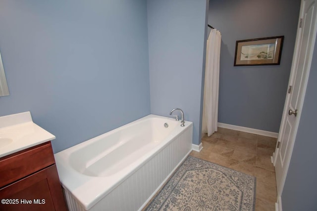 bathroom with vanity and a washtub