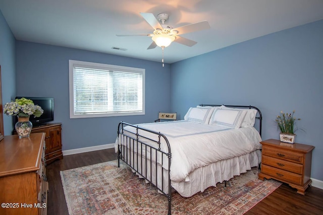 bedroom with ceiling fan and dark hardwood / wood-style flooring