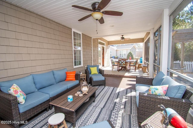 deck with an outdoor living space and ceiling fan