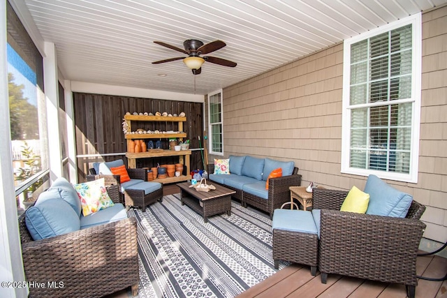 sunroom featuring ceiling fan