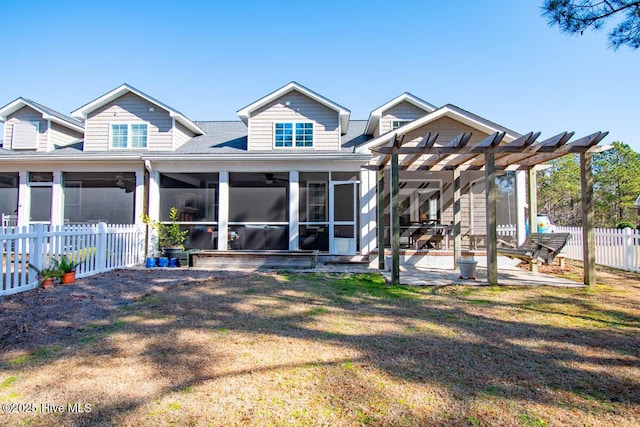 rear view of house featuring a sunroom, a lawn, a patio area, and a pergola