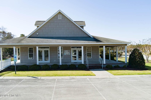 farmhouse-style home with a front lawn and covered porch