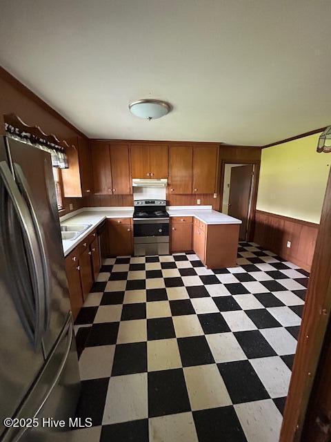 2030 US Highway 17, Merry Hill, NC 27957 - kitchen with stainless steel range oven, tile patterned floors, light countertops, under cabinet range hood, and wood walls