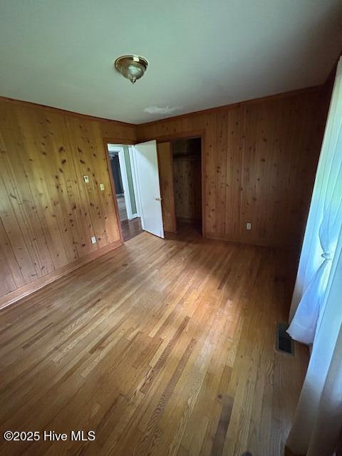 2030 US Highway 17, Merry Hill, NC 27957 - unfurnished bedroom featuring wood finished floors, wood walls, a closet, and baseboards