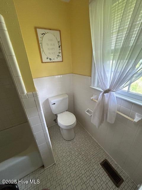 2030 US Highway 17, Merry Hill, NC 27957 - bathroom with toilet, tile walls, and a wainscoted wall