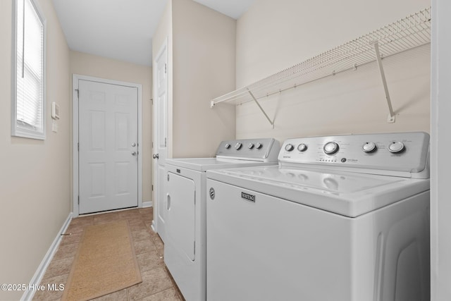 laundry area with separate washer and dryer, laundry area, and baseboards