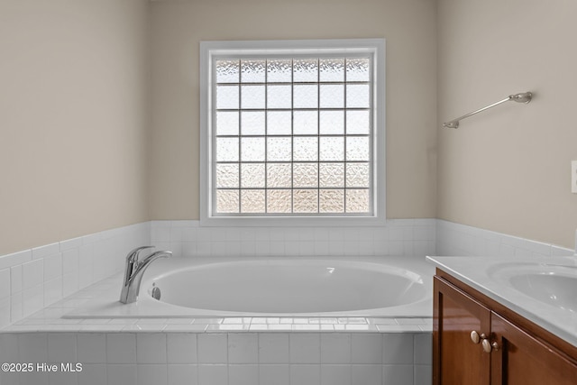 full bathroom with a garden tub and vanity
