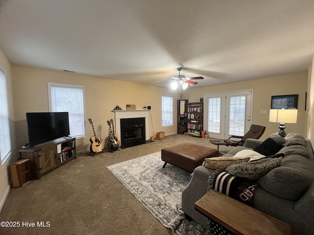 carpeted living room with ceiling fan and plenty of natural light