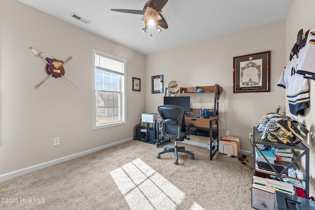 carpeted office space with visible vents, a ceiling fan, and baseboards