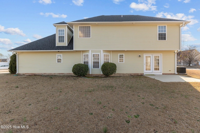 back of house featuring a lawn, a shingled roof, central air condition unit, and a patio area