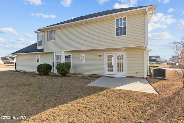 back of house with central AC unit, a yard, and a patio
