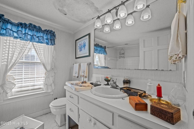 bathroom with vanity, ornamental molding, a textured ceiling, a shower, and toilet