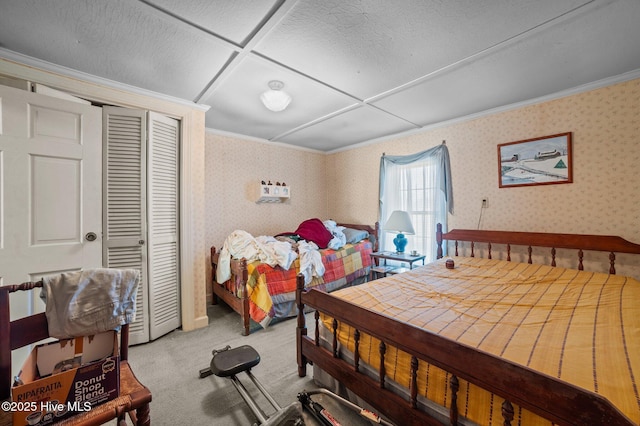 carpeted bedroom featuring ornamental molding and a closet