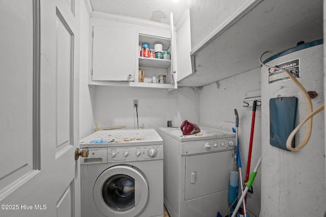 washroom with cabinets and washing machine and clothes dryer