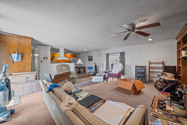 carpeted living room featuring ceiling fan and a textured ceiling