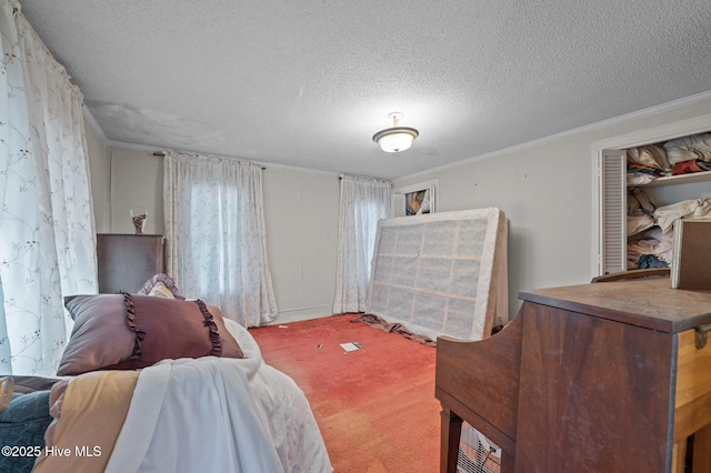 carpeted bedroom featuring crown molding and a textured ceiling