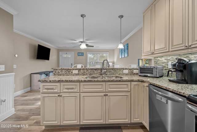 kitchen featuring dishwasher, cream cabinets, ornamental molding, and light stone counters