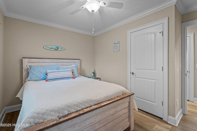 bedroom featuring crown molding, ceiling fan, and light wood-type flooring