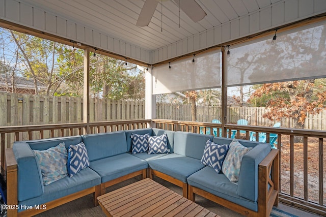 sunroom / solarium featuring ceiling fan