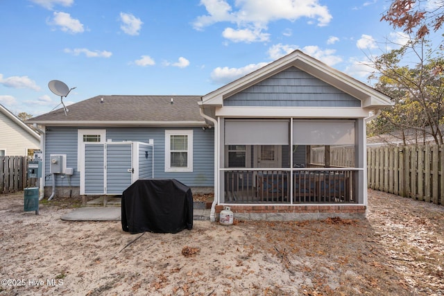 rear view of property with a sunroom