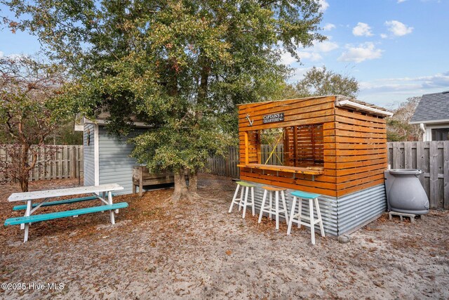 view of outdoor structure featuring exterior bar