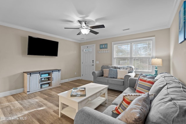 living room featuring ornamental molding, ceiling fan, and light wood-type flooring