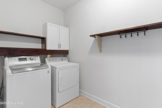 laundry room with cabinets and washer and dryer