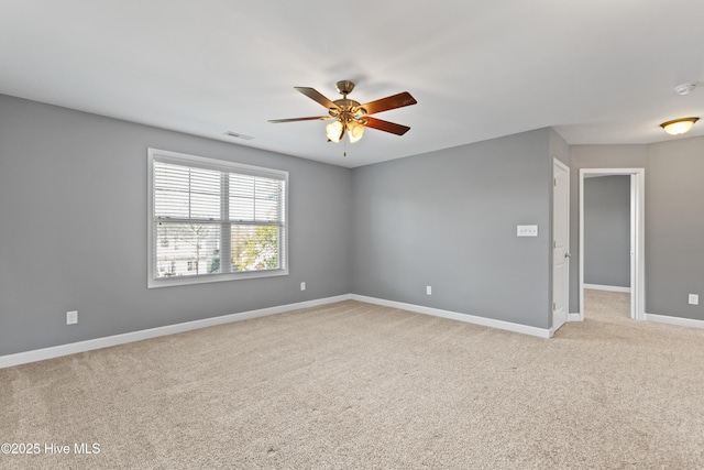 spare room featuring light carpet and ceiling fan