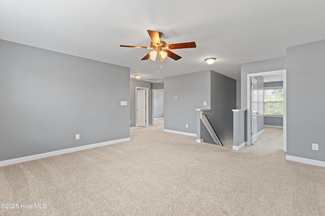 carpeted empty room featuring ceiling fan