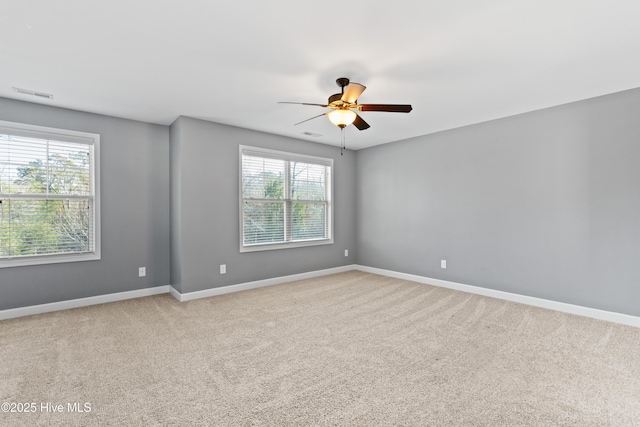 carpeted spare room with ceiling fan