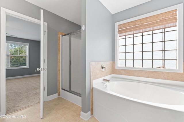 bathroom featuring independent shower and bath and tile patterned flooring